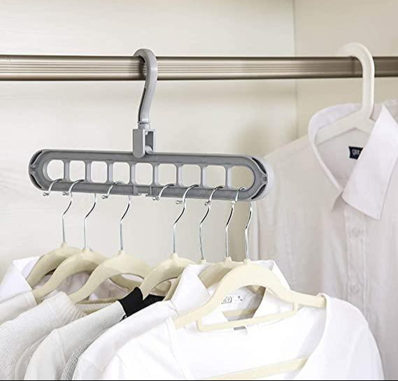 Multi-layered hanger with multiple hooks on a closet rod with shirts in the background