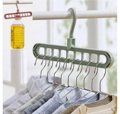 Multi-layered hanger with clothes on a blurred indoor background